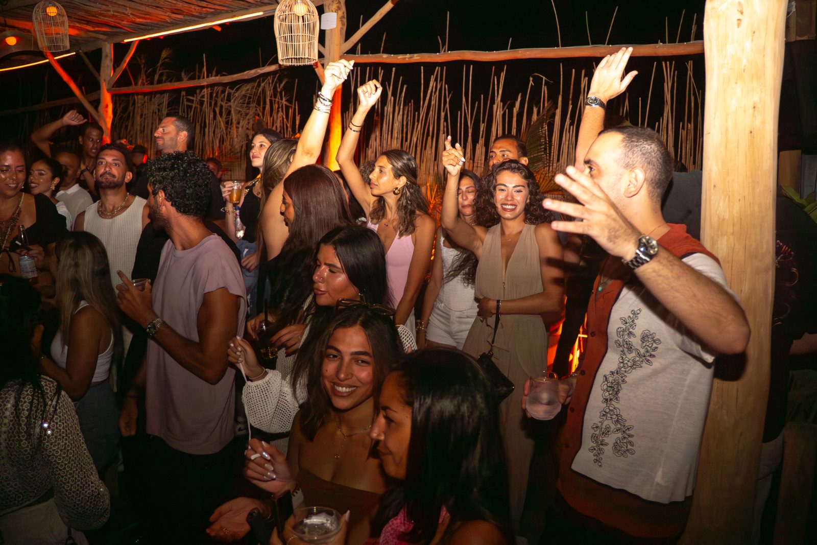 Guests dancing on an open-air dance floor at a Casa Très summer party