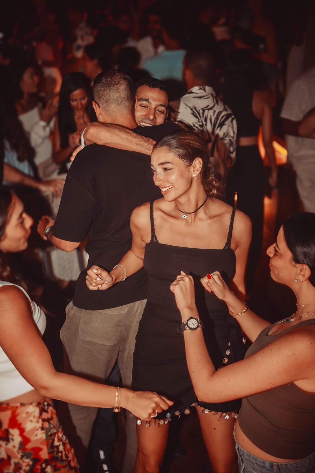 Guests embracing on the dance floor at a Casa Très end-of-year celebration