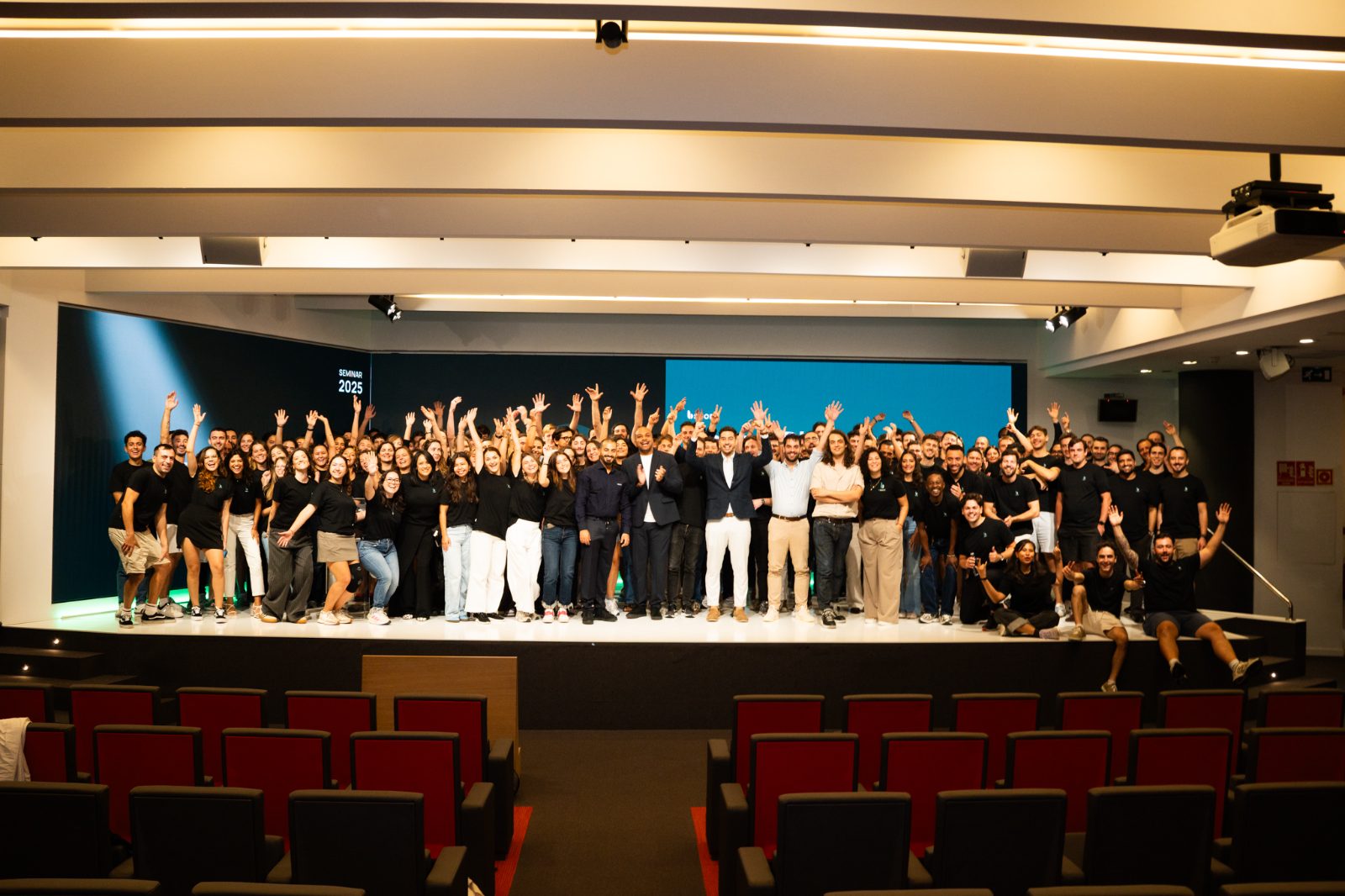 Company group photo on stage at a Casa Très corporate seminar