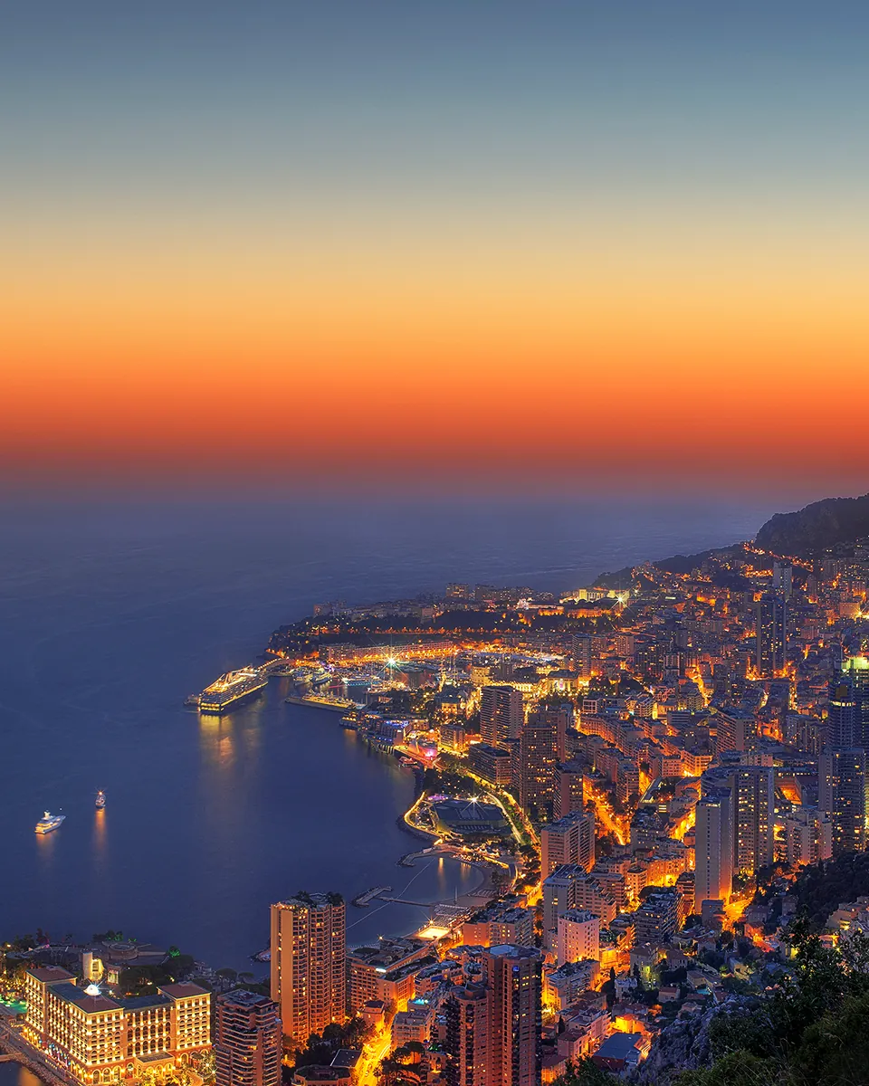 Monaco and its bay at sunset during the Monaco Yacht Show, superyachts at anchor